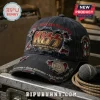 Distressed black KISS baseball cap with red stitching, gold band logo, band member names, and metal pin on equipment case.!