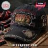Distressed black baseball cap featuring KISS band logos, red embroidery, metal pin, and member names on a wooden surface.!