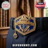 Knights of Columbus hexagonal gold and blue metal belt buckle on a black textured leather belt against a wooden shelf.!