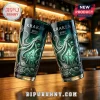 Two dark green glass tumblers with kraken, ship, and treasure chest engraving, marked Kraken 2026 Anniversary on wood bar.!