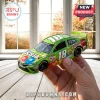 Kyle Busch M&M's Crispy Toyota Camry NASCAR diecast car, bright green, number 18, held in a hand against a window background.!