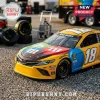Kyle Busch M&M's number 18 yellow Toyota NASCAR die-cast model car on a paved lot with racing tires in the background.!