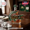 Lacoste branded alligator shaped glass whiskey decanter filled with amber liquid on a dark wooden office desk.!