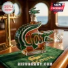 Crocodile-shaped glass liquor decanter with Lacoste branding and a matching green bar mat on a wood counter.!