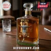 Lionel Messi graphic on a square glass whiskey decanter with a diamond-cut stopper on a wooden desk.!