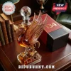 Liverpool FC bird shaped glass whiskey decanter with soccer ball stopper on a wooden desk next to vintage books.!