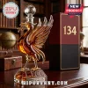 Liverpool FC Liver bird shaped glass decanter filled with amber liquid, topped with a soccer ball stopper on a desk.!