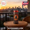 Lord of the Rings 25th anniversary glass featuring a skull helmet and flaming design on a wicker table at sunset.!