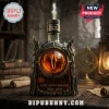Eye of Mordor themed glass liquor bottle with 25th Anniversary 2001-2026 text on a dark rustic library table.!