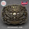 Lynyrd Skynyrd rectangular metal belt buckle with winged skull, crossed rifles, and text on a textured bronze background.!