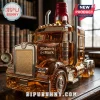 Amber glass liquor decanter shaped like a semi-truck with Maker's Mark branding and a red wax-style cap on a wooden desk.!