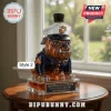 Glass bulldog decanter wearing a US Marine Corps dress blue uniform and white service cover on a wooden table.!