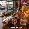 McLaren 60th anniversary race car shaped glass whiskey decanter with number 2 on a wooden desk near a crystal glass.!