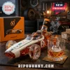 McLaren 60th anniversary race car shaped amber glass whiskey bottle with number 2 decal next to a crystal whiskey glass.!