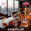McLaren 60th anniversary race car shaped glass whiskey decanter with number 2 and amber liquid on a wooden desk.!