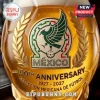 Amber glass soccer ball decanter featuring a gold Mexican national team 100th anniversary emblem and 1927-2027 text.!