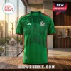 Mexico national team green soccer jersey with red trim, chevron patterns, and crest on a wooden table in front of a city.!