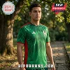 Man wearing a green and red Mexico national soccer jersey with white geometric patterns and Adidas branding outdoors.!
