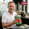 Middle-aged man holding a green World Cup trophy-themed drink cooler with a tap and a straw in a pub setting.!