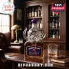 Motörhead Crown Royal Anniversary glass decanter featuring a horned demon stopper on a wooden desk with a crystal tumbler.!