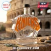 Clear glass bottle shaped like New York Knicks logo with orange lettering and a basketball design, set against the Colosseum.!