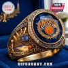 New York Knicks 2025-2026 championship style ring with blue gemstone, orange team logo, and gold metal finish in blue box.!