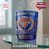 Blue glass Knicks collectible cup with 2026 NBA Champions text, basketball logo, and gold detailing on a glass table.!
