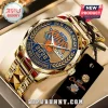 New York Knicks 2026 NBA Champions gold-tone watch with blue dial, orange logo, and metallic link band in presentation box.!