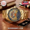 Gold-toned metal New York Knicks championship wristwatch with 2026 NBA logo on a blue and textured gold watch face.!