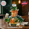 Crystal leprechaun whiskey decanter with emerald green jacket, gold vest, and shamrock hat on a dark wooden table.!