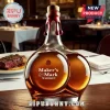 Maker's Mark whiskey bottle with a unique rear-end shape, red wax seal, and cork stopper on a restaurant table.!
