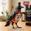 Black crow-shaped glass bourbon whiskey bottle with Old Crow label, amber liquid inside, standing on wooden surface.!