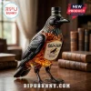 Black crow shaped glass whiskey decanter with Old Crow label, amber liquid inside, set on a wooden desk with vintage books.!