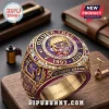 Gold championship-style ring with purple enamel, Oliver Tree portrait, diamonds, and text 1993-2026 on a wood desk.!