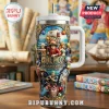One Piece 30th anniversary steel tumbler featuring embossed character art, white handle, lid, and straw on wooden table.!