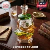 Crystal Oregon Ducks decanter shaped like a mascot head with green and yellow facets on a dark wood desk with books.!