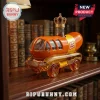 Oscar Mayer Wienermobile glass decanter with a crown stopper resting on a wooden bookshelf background.!