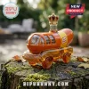 Oscar Mayer Wienermobile shaped glass decanter with a gold crown stopper sitting on a mossy tree stump outdoors.!