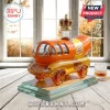 Oscar Mayer Wienermobile shaped glass liquor decanter with a gold crown topper on a glass stand near a window.!