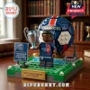 PSG block-style minifigure holding trophy on a green base with a soccer ball, Eiffel Tower model, and championship signs.!