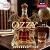 Ozzy Osbourne shaped glass decanter with wings and a gold crown filled with amber liquid on a dark wooden desk.!