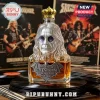 Ozzy Osbourne shaped glass liquor bottle with gold crown topper, featuring bat emblem and text plaque on a vinyl record stack.!