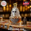 Glass whiskey decanter shaped like Ozzy Osbourne wearing a crown and sunglasses, with a bat-shaped commemorative label.!
