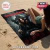 Ozzy Osbourne beach towel featuring graphic of musician on throne with skulls and red roses on a sandy beach background.!