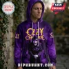 Man wearing a purple long-sleeve hoodie featuring a graphic of Ozzy Osbourne in a top hat with yellow text branding.!