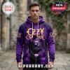 Man wearing a purple Ozzy Osbourne graphic hoodie with yellow text and a bat-winged figure illustration.!