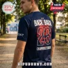 Man wearing a navy soccer jersey with Back 2 Back 26 Champions D'Europe text and red floral graphics on the back.!