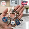 Paris Saint-Germain metal keychain featuring team logo, trophy, soccer ball, winner plaque, and Eiffel Tower charms.!