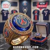 Gold Paris Saint-Germain 2026 UEFA Champions League championship ring with blue center stone and team logo.!