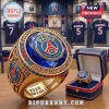 Gold championship ring with a large blue gem, featuring Paris Saint-Germain FC branding and 2026 UEFA Champions League text.!